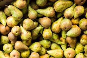 Green pears on sale at the local market. Pears background