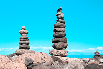 Fototapeta na wymiar two pyramids of gray balanced rocks symbolizing harmony and balance 