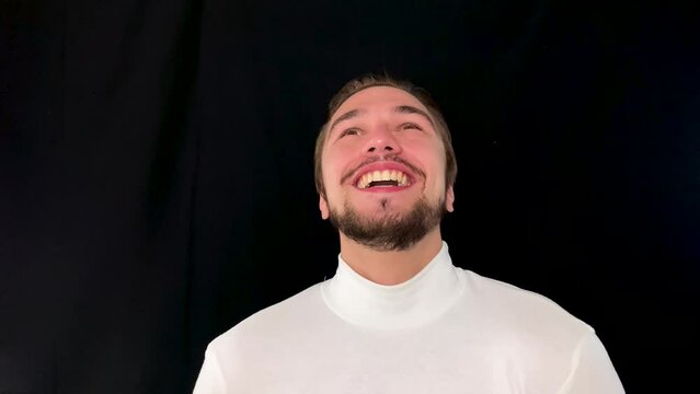 Happy man reacting to good news with a warm smile, joyous moment of positivity