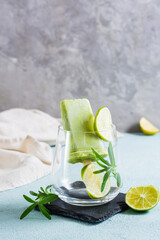 Diet popsicle made from avocado and lime in a glass on the table. Vertical view