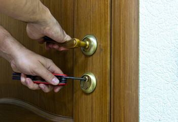 A burglar opens the door of an office or home. The thief picks up a lockpick for the door. Office...
