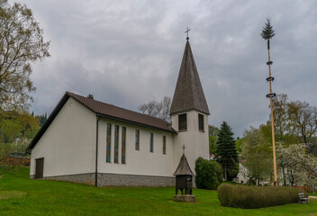 Fototapeta na wymiar Cloudy dark evening in spring time in Buchenau village