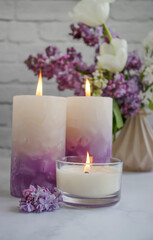Obraz na płótnie Canvas aroma candle flower lilac in the apartment