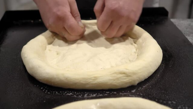 Cooking buns. Rustic style. Process of making bread. kneading dough, cooking buns. Camera movement, panorma of small buns on table. Production of wheat bread. Bakery. Workflow