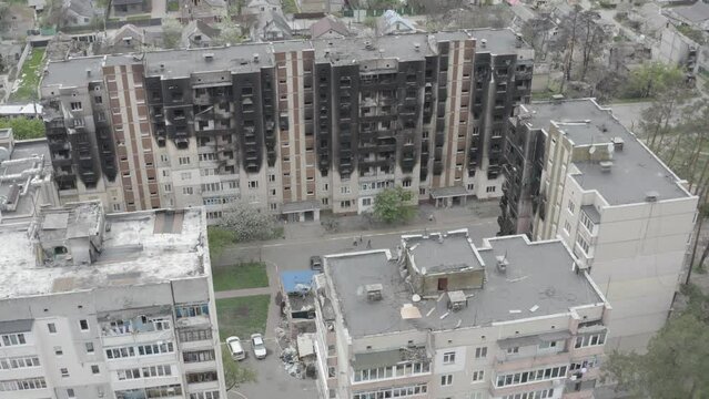 Damaged residential building in the Bucha city, Kyiv region during the fighting after the Russian attack on Ukraine. Russian-Ukrainian war. Aerial. Fire in the house. 