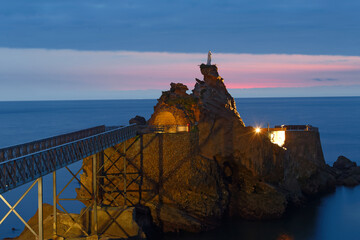 Biarritz, France, Rock of the Virgin -Rocher de la Vierge in French on dramatical sunset over...