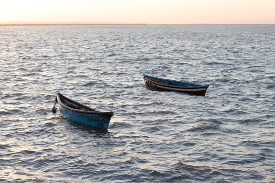 Beautiful landscape of Fishing boats on the sea. two boats and very small boats for fishing. located in Diu district of Union Territory Daman and Diu, India