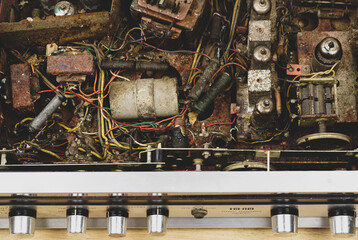 Old electronic circuit. Electronic tubes, capacitors, resistors,the power cord is broken, rust corrosion.  