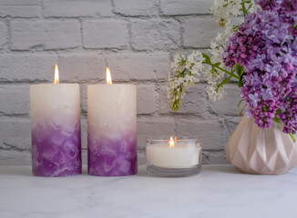 Obraz na płótnie Canvas aroma candle flower lilac in the apartment