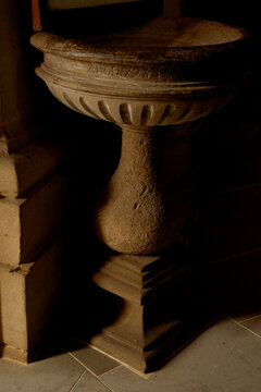 Stone baptismal font in a church in Spain