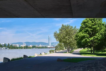  the danube river on a beautiful sunny day and the business center of the city and the skyscrapers of vienna in the background © sebastiangora