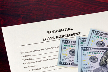 Fototapeta premium Residential lease agreement and cash money. Rental contract, eviction and housing crisis concept.