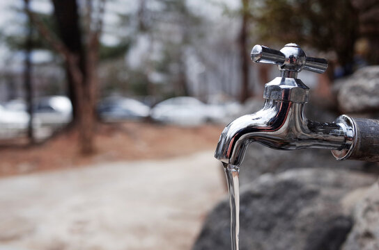 Faucet with running water in the park.
