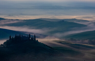 morning fog over mountains in Tuscany Italy