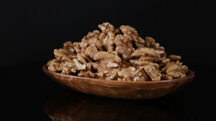 walnuts on a mirror table in the dark 