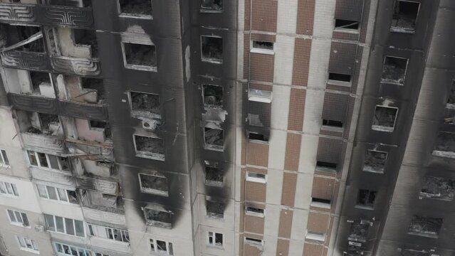 Damaged residential building in the Bucha city, Kyiv region during the fighting after the Russian attack on Ukraine. Russian-Ukrainian war. Aerial. Fire in the house. 