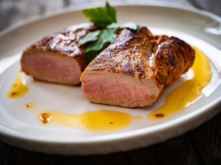 Roasted pork loin on wooden table
