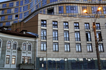 Large modern building attached to smaller older house in Bucharest