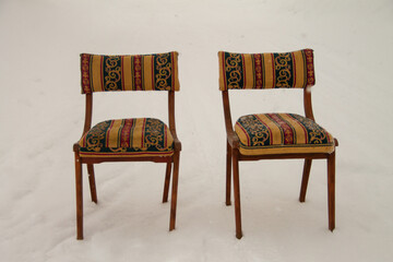 vintage chairs outside during a snowfall