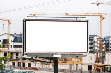 Blank white advertising billboard in front of the construction site