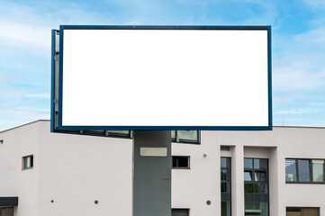 Blank white billboard for advertisement in front of the building. Industrial area.
