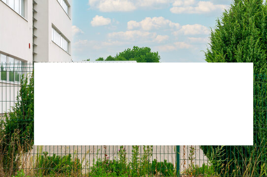 Blank white banner for advertisement on the fence of the office building