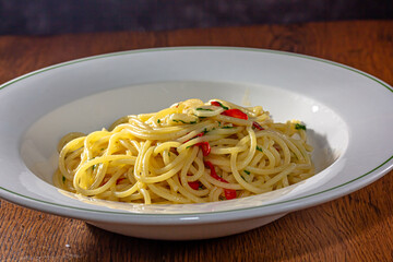 Vegetarian Italian Pasta Spaghetti Aglio E Olio with garlic bread, red chili flake, parsley, parmesan cheese.
