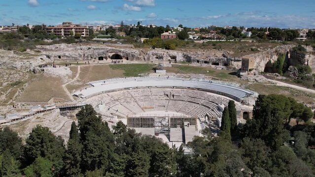The Greek Theater of Syracuse is located on the southern slopes of Temenite Hill, overlooking the modern city of Syracuse in southeast Sicily.