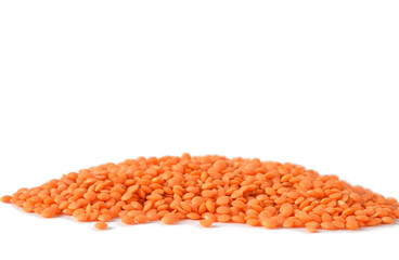 Orange lentils are beautifully laid out on a white background. Vegetarian food.