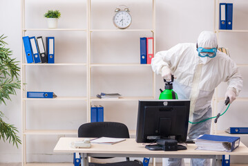 Old male contractor in office disinfection concept