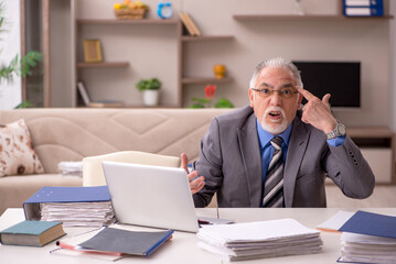 Fototapeta premium Old male employee working from home during pandemic
