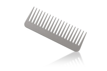 Gray and beige hair comb isolated on white background with reflection