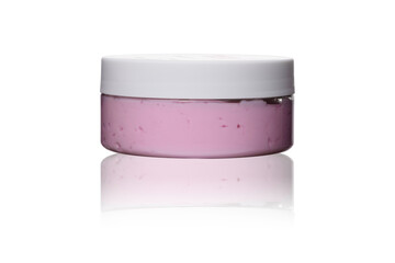 pink cream souffle or scrub in transparent plastic jar with white lid on white isolated background with reflection 