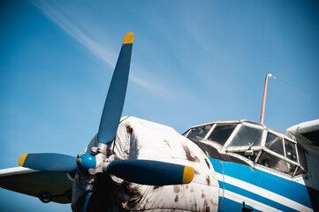 The propeller of a retro aircraft against the blue sky.