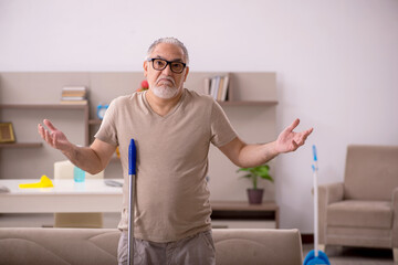 Old man doing housework at home