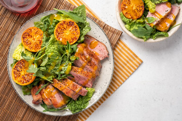 Salad with roasted duck breast and grilled orange tangerines. Natural organic nutrition.