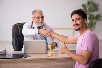Young male patient visiting old male doctor