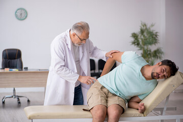 Young male patient visiting old male doctor