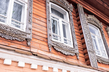 Beautiful old windows. An architectural monument. Old Russian style. Wooden architecture. An old carved frame. Architectural decorative element.