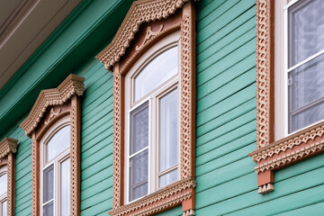 Beautiful old windows. An architectural monument. Old Russian style. Wooden architecture. An old carved frame. Architectural decorative element.