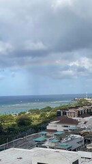 Long rainbow over the emerald Hawaiian beach, Ala Moana Beach Oahu Island, Hawaii year 2022 spring