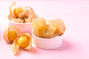 Cape gooseberry or golden berry (Physalis peruviana) on pink background