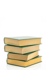Literature and reading concept. Books stack with green covers on a white background.Reading of books. Knowledge concept.Reading and education. 
