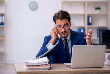 Young male employee working in the office