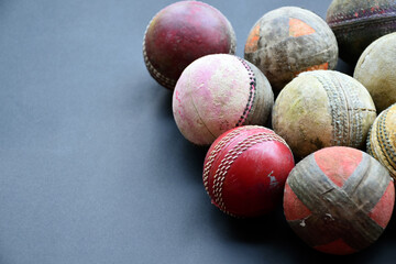 Old and used cricket balls on dark background used for cricket practice, soft and selective focus.