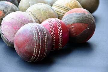 Old and used cricket balls on dark background used for cricket practice, soft and selective focus...
