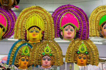 Colorful chhou masks of Hindu Goddess Durga, on display for sale at handicrafts fair, Kolkata, West...