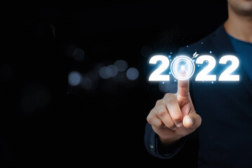 Businessman hand pointing in the new year 2022.,Business development and growth concept.business strategy. New Goals and Visions for Next Year 2022.