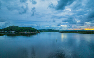 Autumn sunrise and rain clouds over the bay