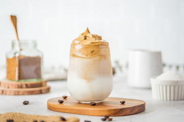 Dalgona coffee with fluffy cream served on wood tray.Homemade trendy beverage menu on social media